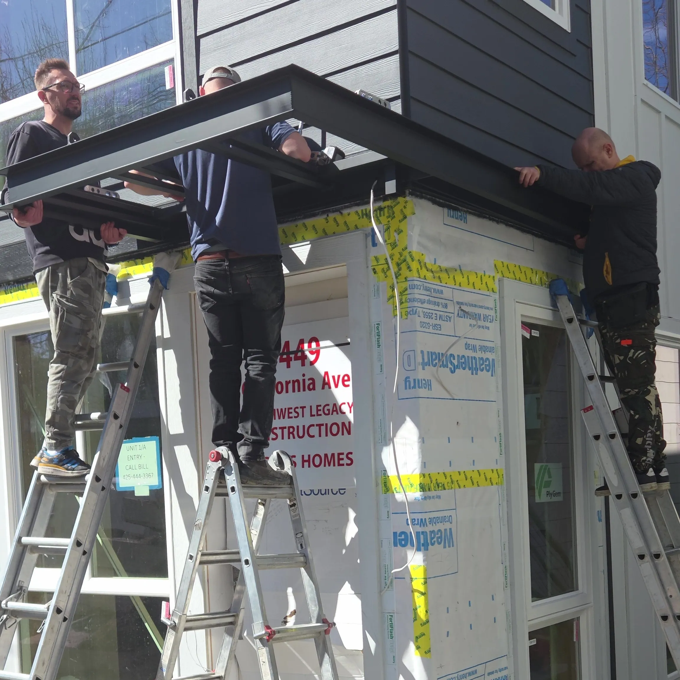 Brothers Metal crew installing a custom metal canopy on a home